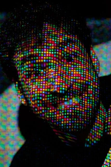 Portrait of Zach grinning with an RGB subpixel grid projected across his face