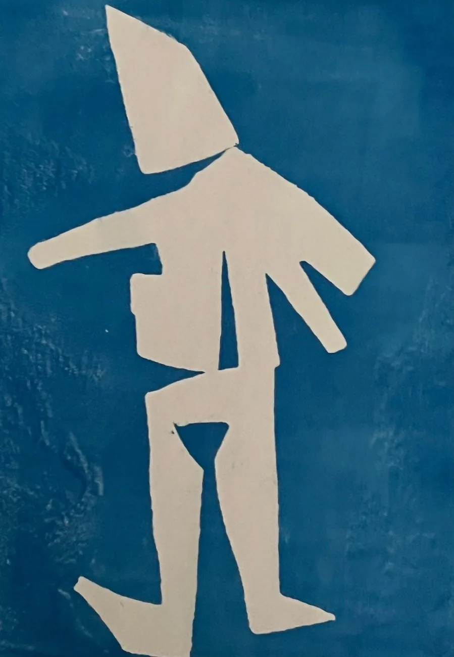 Holly's original monoprint: a paper-cut figure on blue